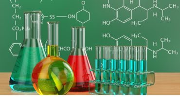 Chemical flasks and blackboard with formulas. 3d